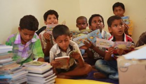 Village children reading the books in the Library