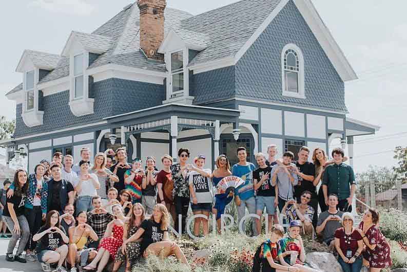 LGBTQ+ youth posing for a picture in front of Encircle house