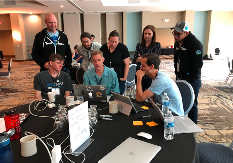 A group of higher education technology enthusiasts discuss the Education Data Architecture at the Salesforce.org Open Source Community Sprint in 2019.