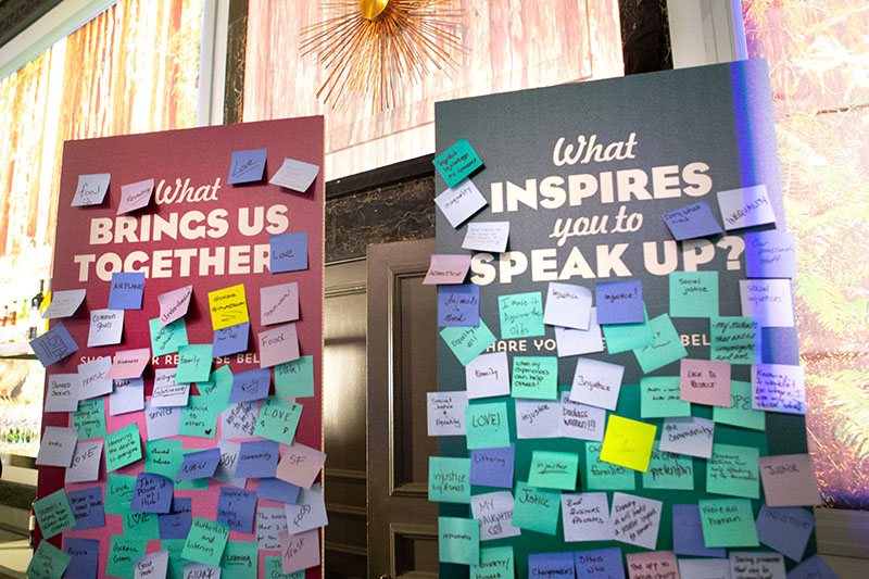 Posters with sticky notes saying “What brings us together?” and “What inspires you to speak up?” from Dreamforce