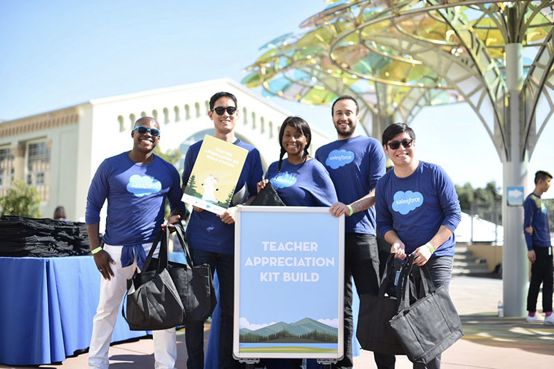 Salesforce employees participating in a kit building activity, with kits to be donated to local Bay Area teachers.