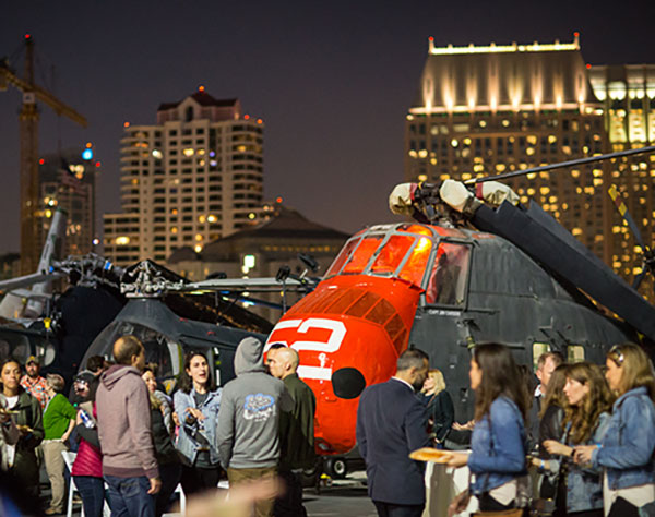 Photo of last year’s Higher Ed Summit reception on an aircraft carrier in San Diego
