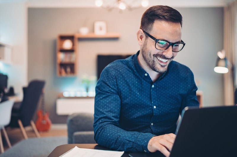 Organization staff member applying for the Pro Bono program on his laptop in his living room