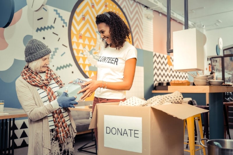 Volunteer working at a nonprofit organization, giving resources and supplies to a constituent