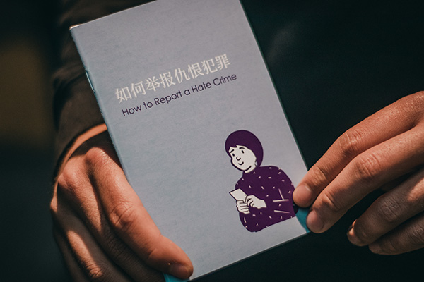 Person holding paper booklet 