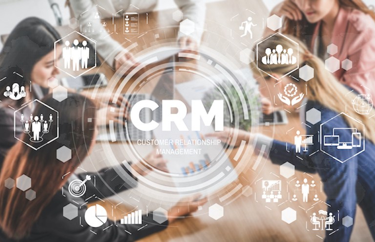 Image of people having a meeting with a CRM graphic overlaid