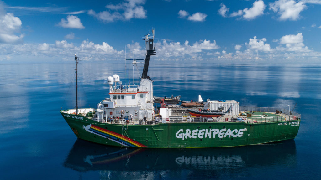 Greenpeace ship in the middle of the ocean.