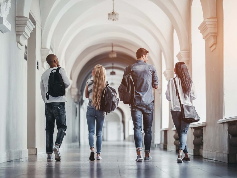 College students walking down a hallway talking