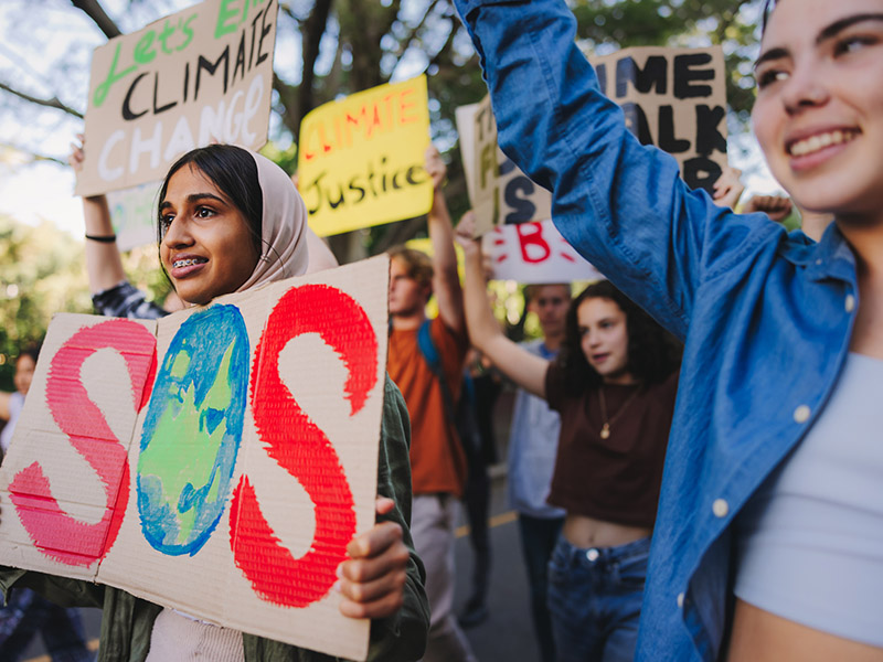 Young people holding up signs to protest climate change