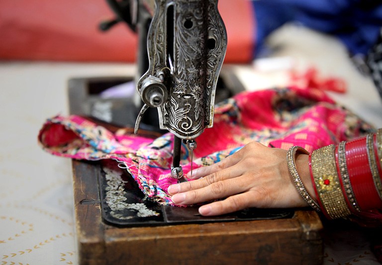 hands displayed using a sewing machine