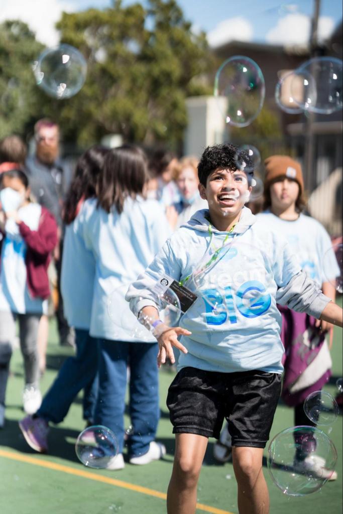 Presidio Middle School student playing with bubbles at Salesforce’s Back to School education celebration in September 2022.